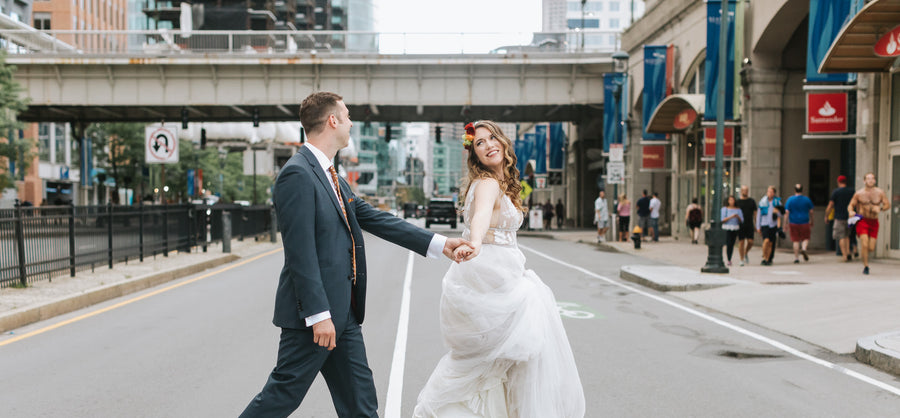 wedding photo of erin + jack crossing street in boston