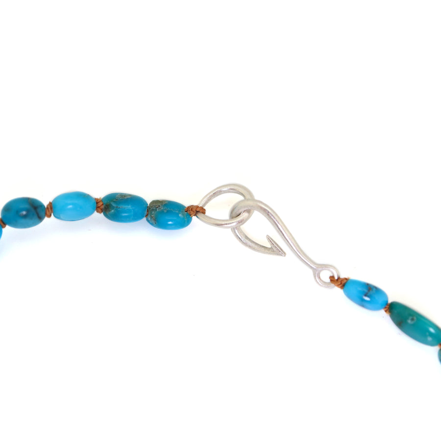 varying hades of tropical blue turquoise are strong on burnt sienna silk with silver clasp