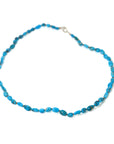 varying hades of tropical blue turquoise are strong on burnt sienna silk with silver clasp