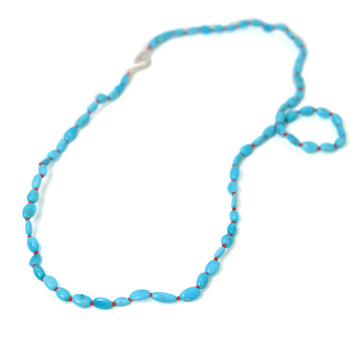 22in turquoise necklace on coral silk with silver clasp.