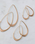 Photo of all three pairs of facet hoops in 14k rose gold in three sizes: large, medium, small