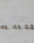 three pairs of silver rose garden studs in varying sizes.