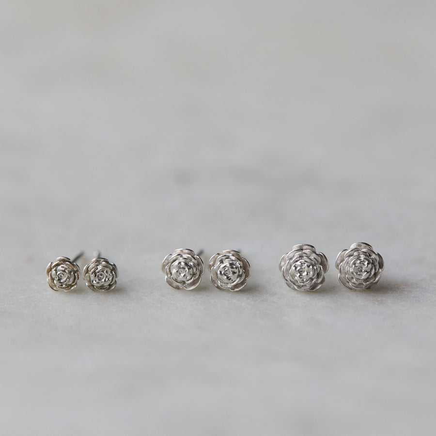 three pairs of silver rose garden studs in varying sizes.