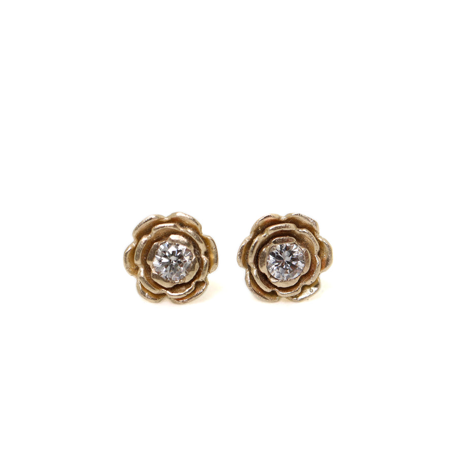 floral earrings studs made of 14k yellow gold, with a diamond set in the center of each flower.