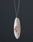 large sized mother of pearl pendant necklace in oxidized silver with 14k gold barnacles