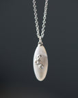 medium sized mother of pearl pendant necklace in bright silver with barnacles