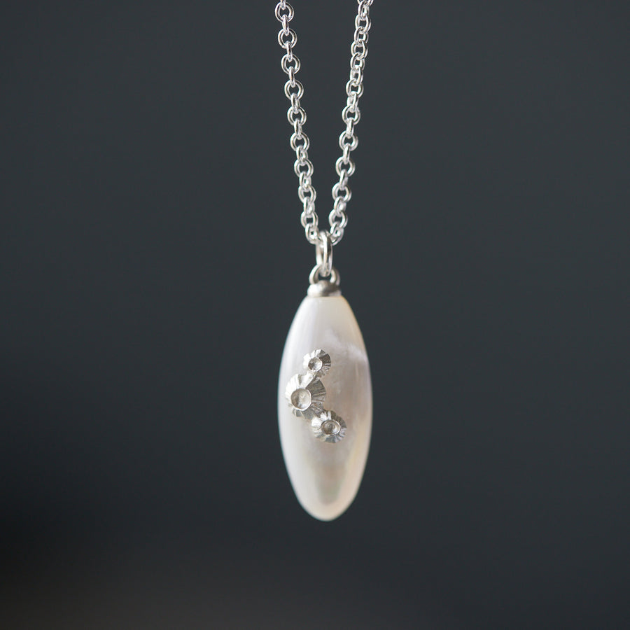 medium sized mother of pearl pendant necklace in bright silver with barnacles