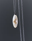 medium sized mother of pearl pendant necklace in oxidized silver with 14k gold barnacles