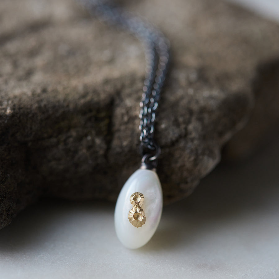 little sized mother of pearl pendant necklace in oxidized silver with 14k gold barnacles