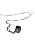 black spiral moon snail pendant necklace with gold barnacles