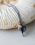 black whelk shell pendant with gold barnacles on chain