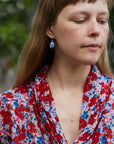 Tiny handcarved turret shell in silver by Hannah Blount, on person