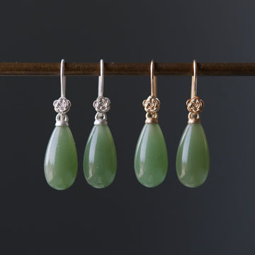 sage green nephrite jade teardrops hang beneath silver and gold rose ear wires