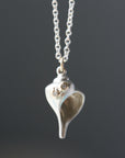 Whelk shell necklace in bright silver with diamond barnacles