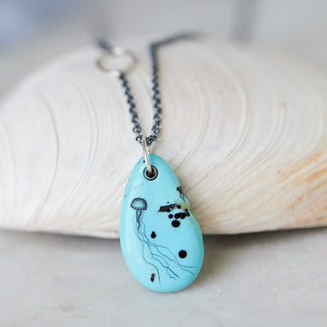 kingman turquoise pendant with inked illustration of jellyfish on oxidized silver chain