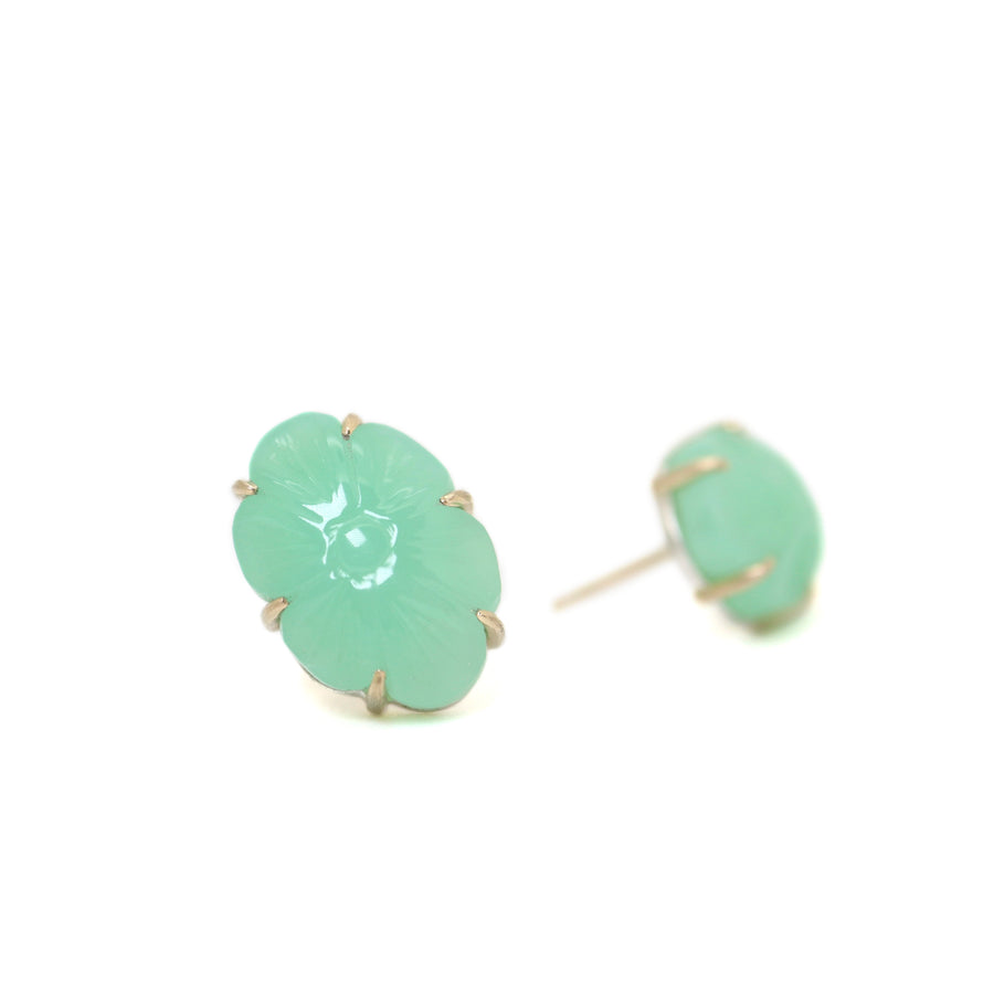 13.06ct Carved Chrysoprase Studs on a white background. The Carved Chrysoprase is set with six 14k gold prongs. The Carved Chrysoprase is oval shaped with a carved flower motif. One of the studs is in profile to show the 14k gold post and bright silver stone seat. 