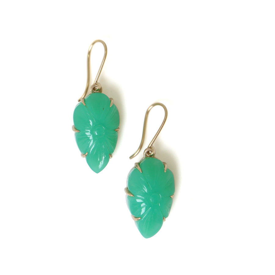 Two 17.93ct Carved Chrysoprase Earrings on a white background. The carved Chrysoprase is set with six 14k gold prongs and gold ear wires. The Chrysoprase is shaped like a shield and carved with a flower motif. 