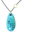 kingman turquoise pendant with inked illustration of a school of tiny fish on oxidized silver chain with gold details