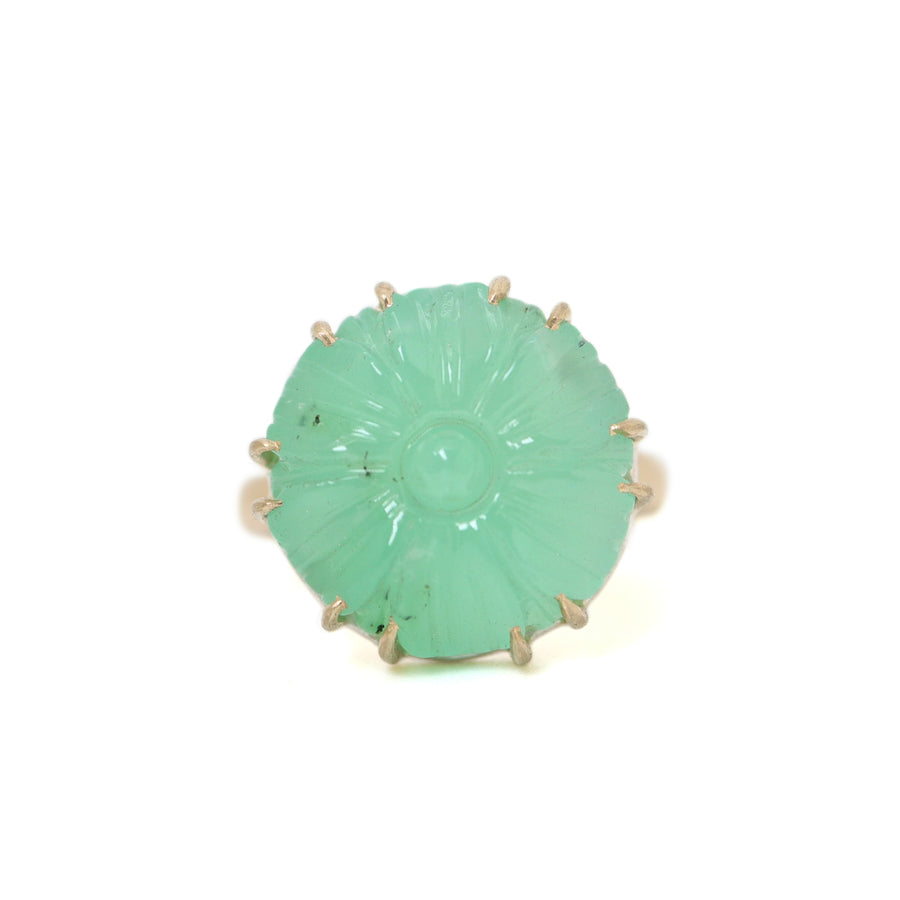 9.39ct Carved Chrysoprase Vanity Ring on a white background. The Chrysoprase is carved like a flower with twelve gold prongs securing it to it's setting. The Chrysoprase has a few small black speckles on it's left side.