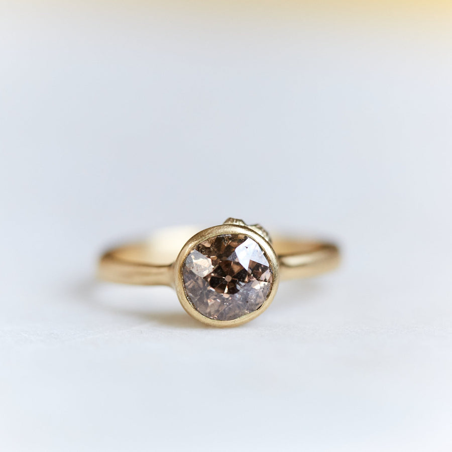 A 1.38ct diamond ring. The diamond has a chestnut hue and is set in 18k gold with an 18k gold band. The setting is encrusted with 14k gold barnacles. The ring is viewed from the front and is set on a white background.