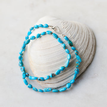 Kingman turquoise strand with silver fish hook clasp and burnet sienna-hued silk by Hannah Blount