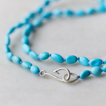 pale blue kingman turquoise beads are strung together on lavender silk in this nautical necklace, with a silver fish hook clasp