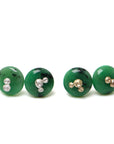 two pairs of green garnet earring studs, the left pair has silver barnacles and the right pair has gold barnacles.