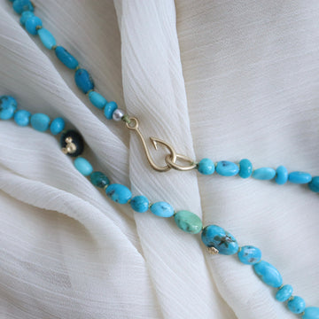 Turquoise strand necklace with gold barnacles by Hannah Blount