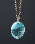 kingman turquoise pendant with inked illustration of an octopus on a gold chain