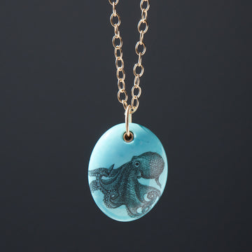 kingman turquoise pendant with inked illustration of an octopus on a gold chain