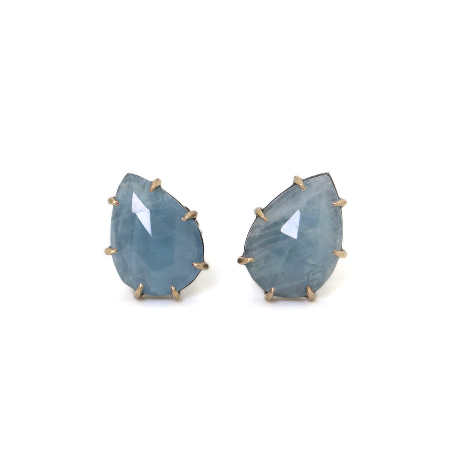 teardrop aquamarine faceted stones set in earring studs with gold prongs