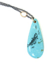 kingman turquoise teardrop bead with ink scrimshaw of codfish and little fishes. Necklace with gold and oxidized silver.