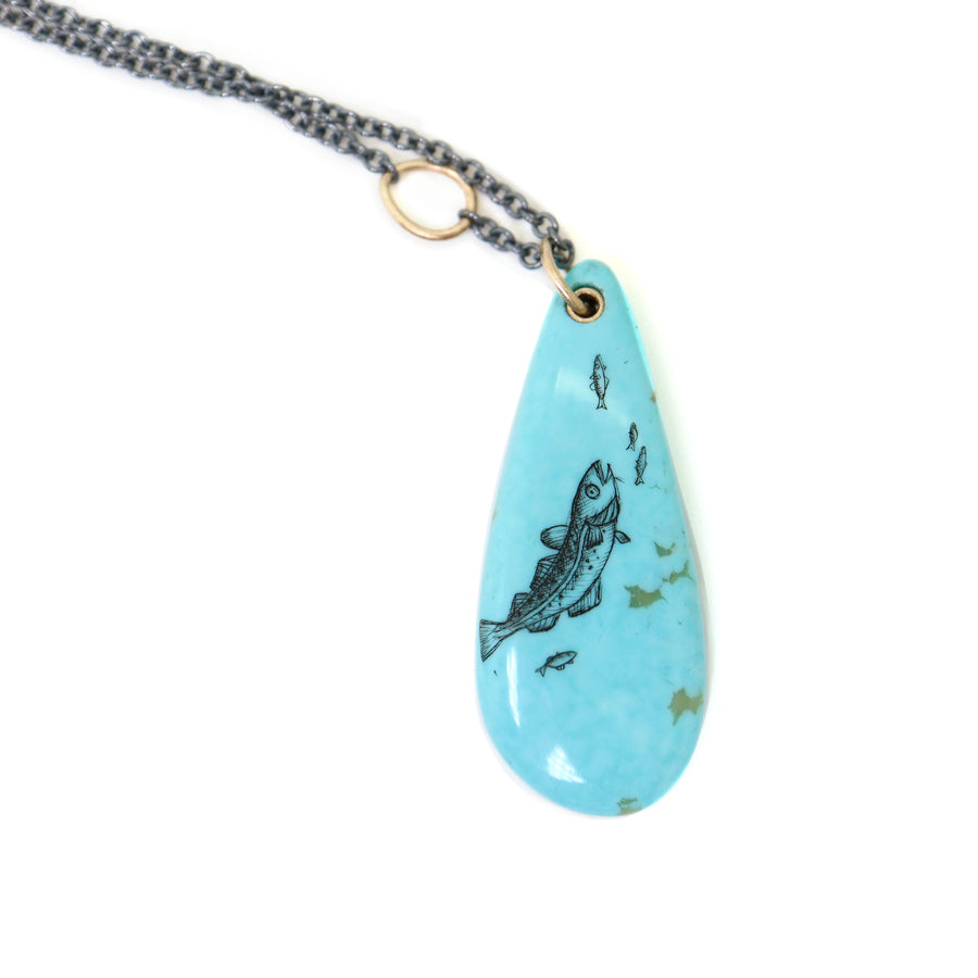 kingman turquoise teardrop bead with ink scrimshaw of codfish and little fishes. Necklace with gold and oxidized silver.