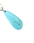 kingman turquoise teardrop bead with ink scrimshaw of codfish and little fishes. Necklace with gold and oxidized silver.