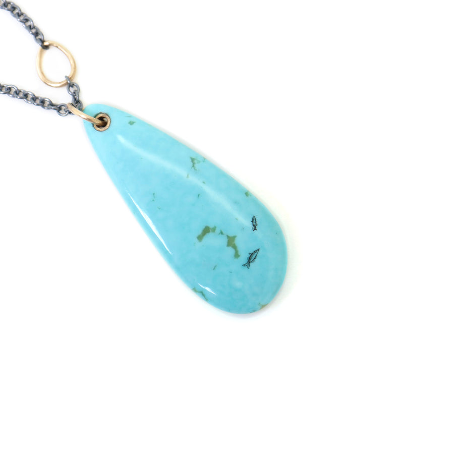 kingman turquoise teardrop bead with ink scrimshaw of codfish and little fishes. Necklace with gold and oxidized silver.