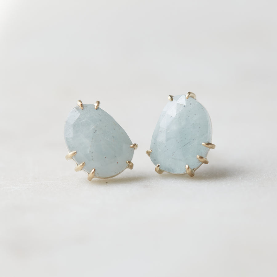 pale grey blue aquamarine stones with gold prongs. stud earrings