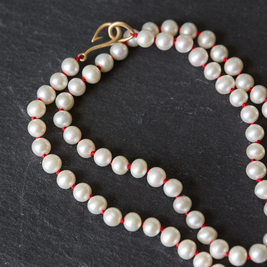 knotted freshwater pearls on red silk