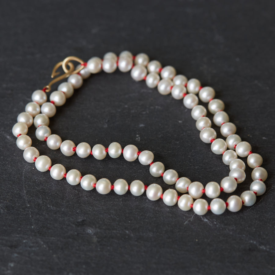 knotted freshwater pearls on red silk