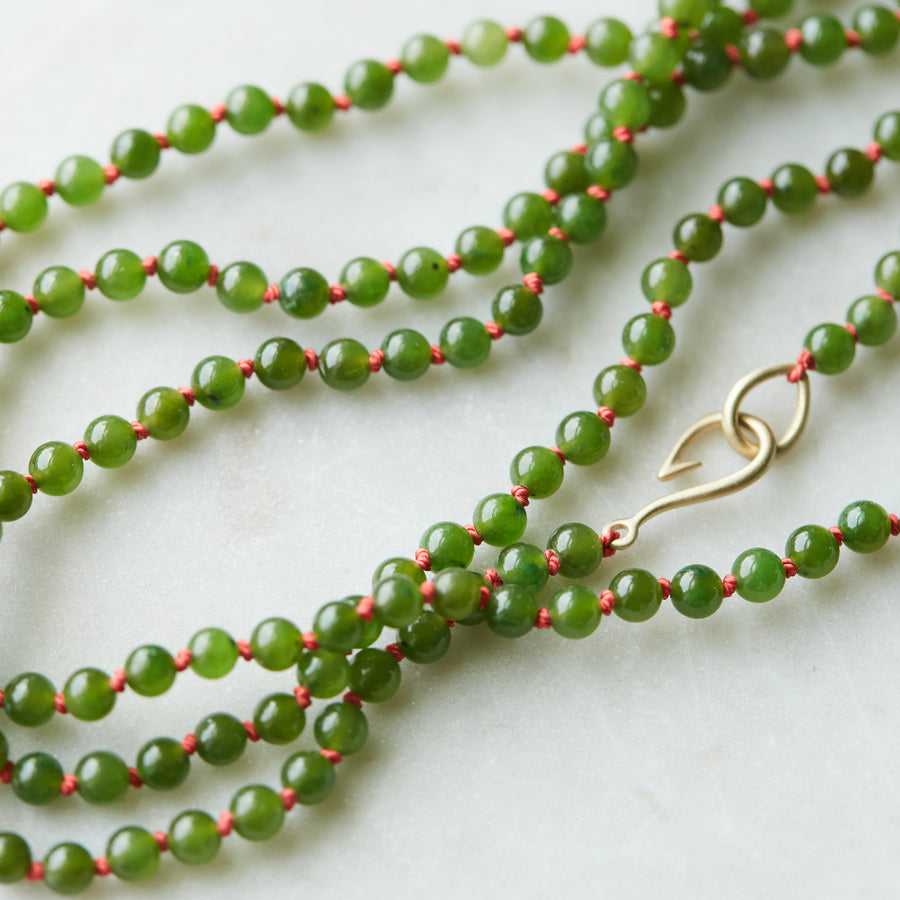 Green jade double strand with coral silk and gold clasp by Hannah Blount