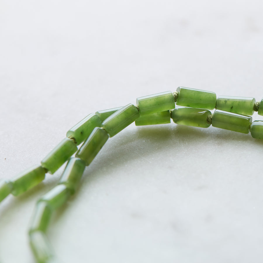 Green jade strand necklace with gold clasp by Hannah Blount