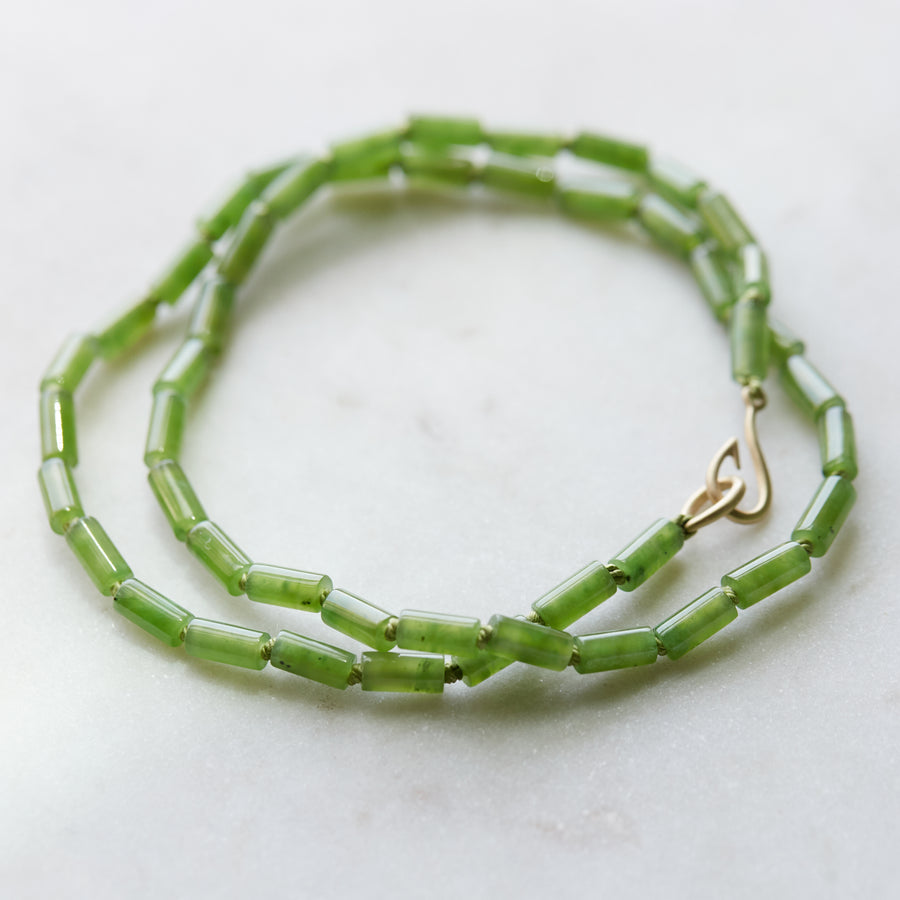 Green jade strand necklace with gold clasp by Hannah Blount