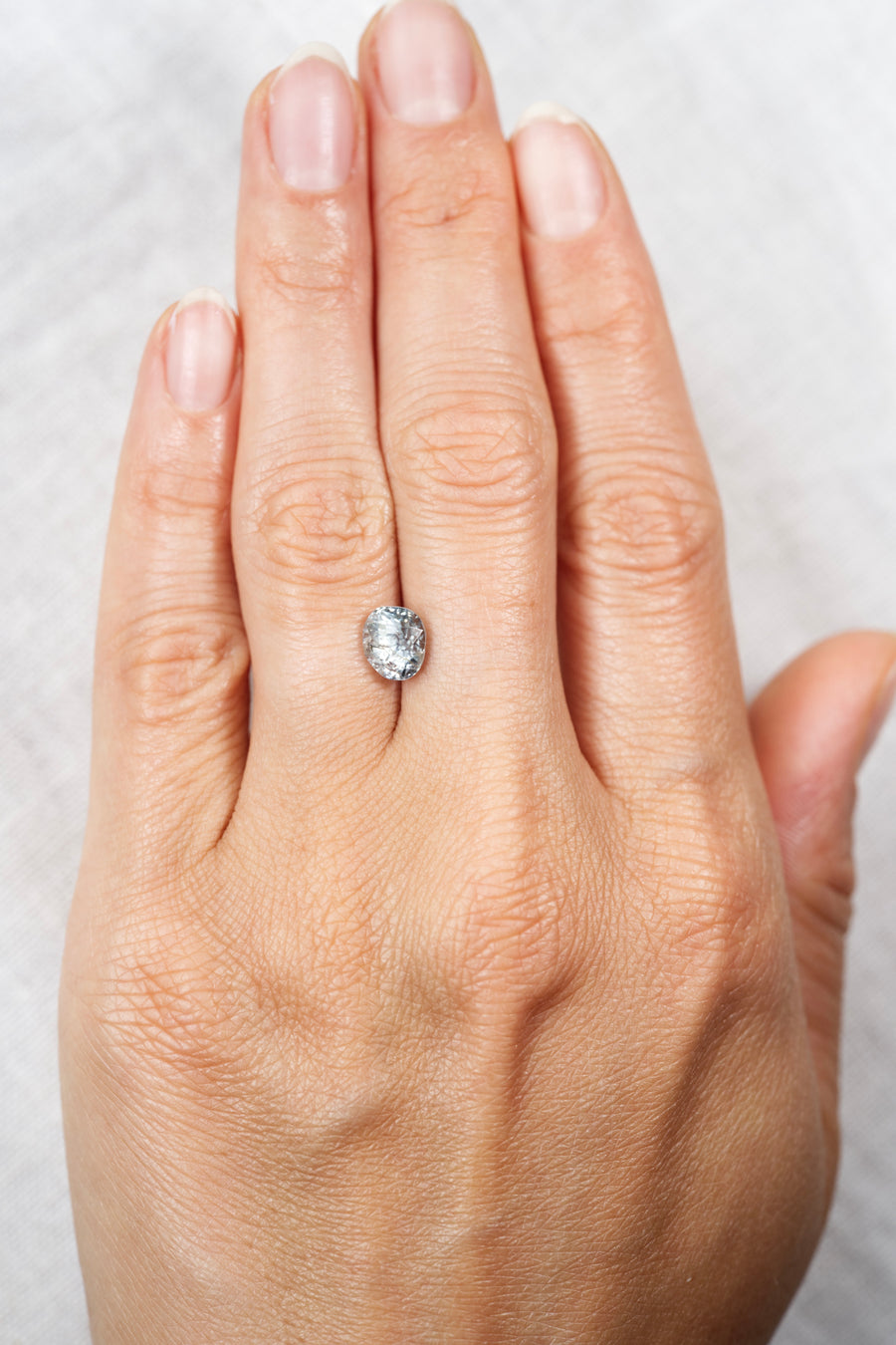 2.415ct Blue Montana Sapphire on hand for scale