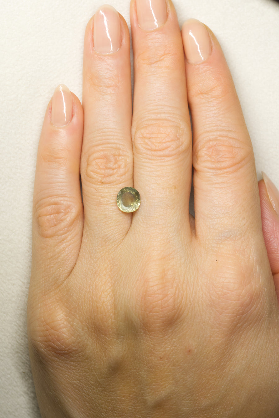 2.365ct Green Montana Sapphire on hand for scale