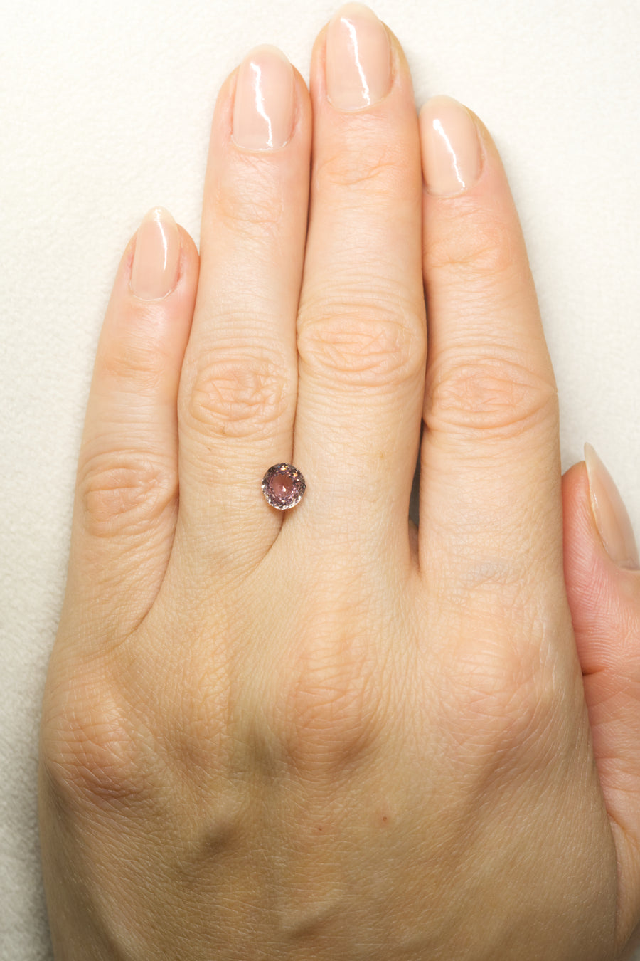 1.635ct Pink Montana Sapphire on hand for scale