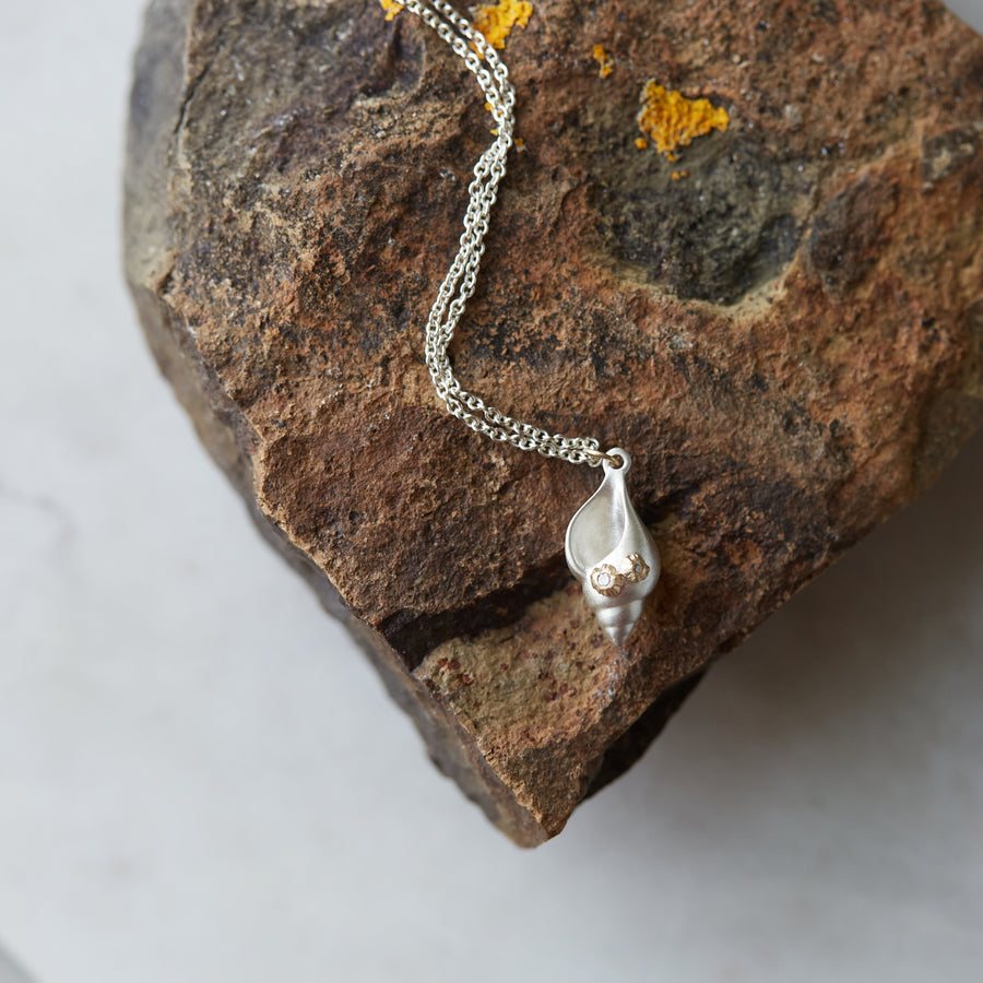 silver spiral tulip shell with two gold barnacles with diamonds, on a silver chain