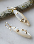 Large mother of pearl earrings with gold barnacles by Hannah Blount